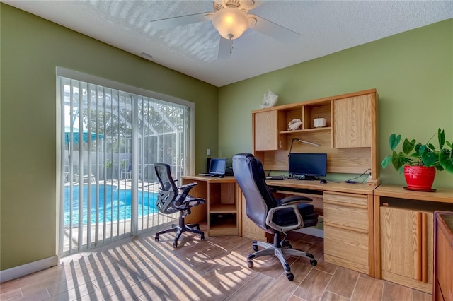 home office featuring a textured ceiling and ceiling fan