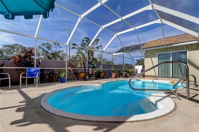 view of pool with a lanai and a patio area