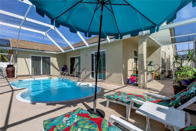 rear view of house with a lanai and a patio area