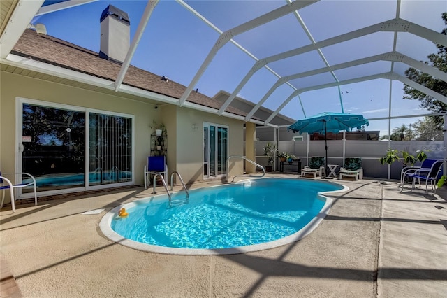 view of pool featuring a patio area and glass enclosure