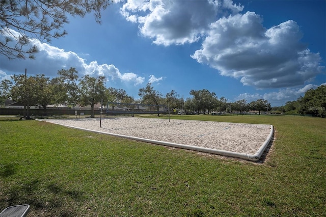 view of home's community featuring a lawn and volleyball court