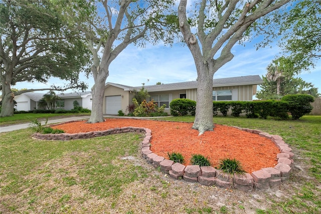 ranch-style house with a front yard and a garage