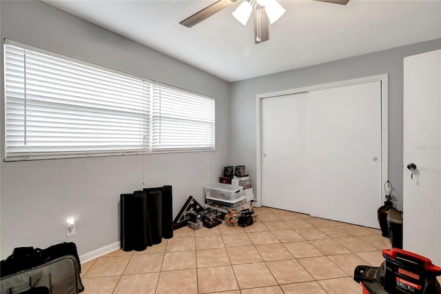 interior space featuring a closet, ceiling fan, and light tile patterned flooring