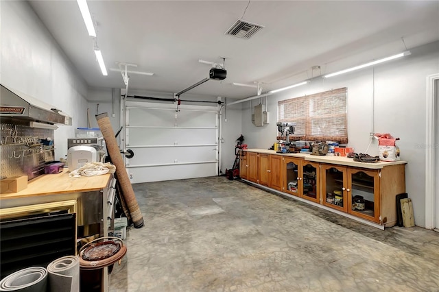 garage featuring a workshop area and a garage door opener