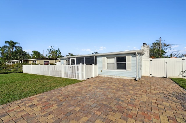 view of front of property with a front lawn and a sunroom