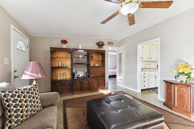 living room featuring ceiling fan and sink