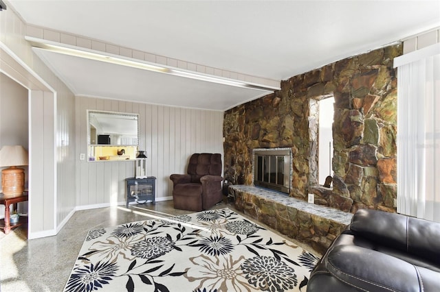 living room with a stone fireplace