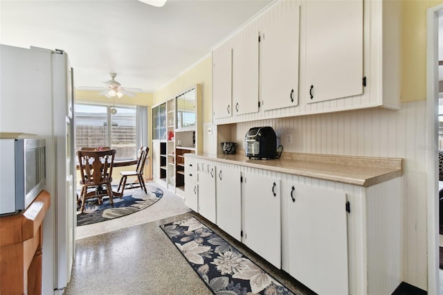 kitchen featuring white cabinetry and ceiling fan