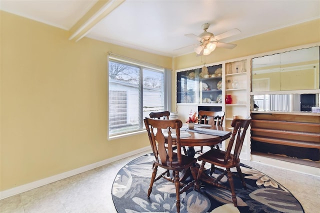 dining area featuring ceiling fan and beam ceiling