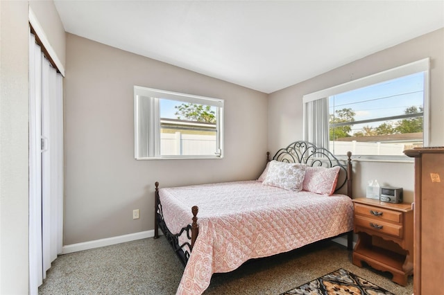 bedroom with light carpet and a closet