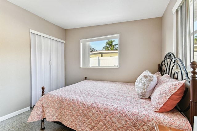 bedroom with multiple windows and carpet floors