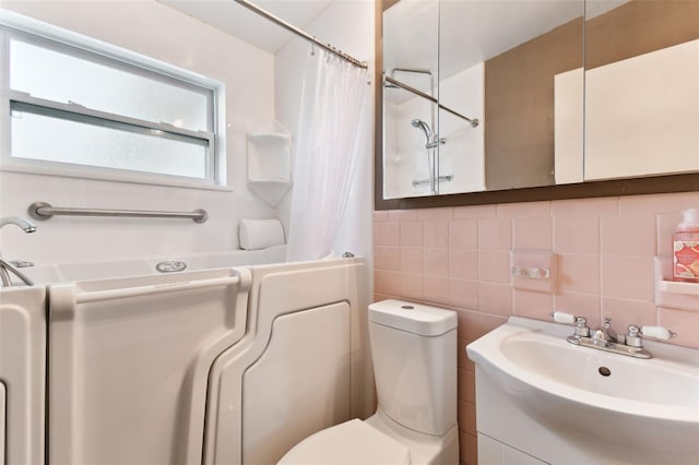 bathroom with toilet, tile walls, tasteful backsplash, vanity, and a shower with shower curtain