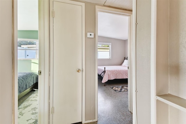 corridor featuring lofted ceiling