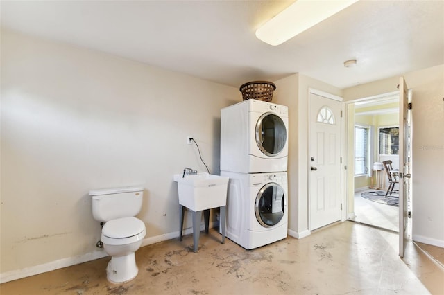 clothes washing area with stacked washer and dryer