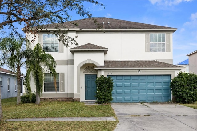 front facade with a garage and a front lawn