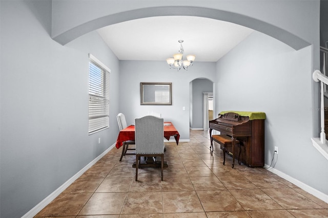 tiled dining area featuring an inviting chandelier