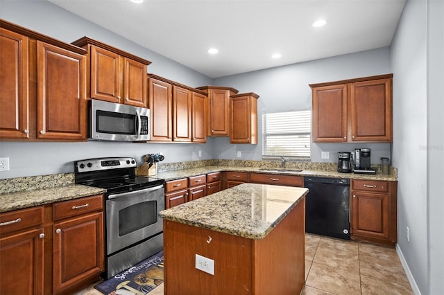 kitchen with a kitchen island, light stone countertops, sink, and stainless steel appliances