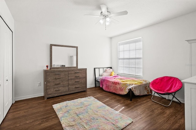 bedroom with a closet, ceiling fan, and dark hardwood / wood-style floors