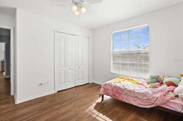 bedroom with ceiling fan, a closet, and dark hardwood / wood-style flooring