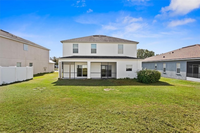 rear view of house with a lawn