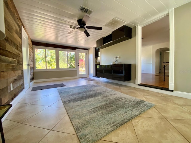 unfurnished living room with ceiling fan, light tile patterned floors, and wooden ceiling