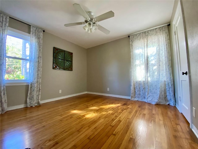 unfurnished room featuring hardwood / wood-style floors and ceiling fan