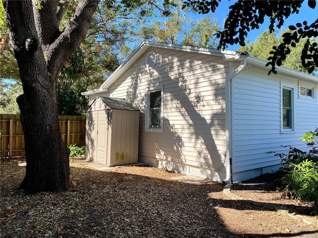 view of side of property with a storage unit