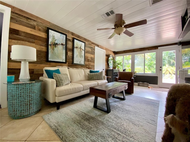 living room with tile patterned flooring, ceiling fan, wooden ceiling, and wooden walls