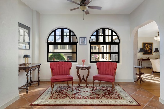 living area featuring ceiling fan and light tile patterned floors