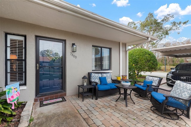 doorway to property featuring a patio and an outdoor hangout area