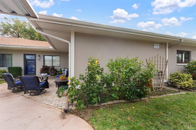 view of side of home with a patio