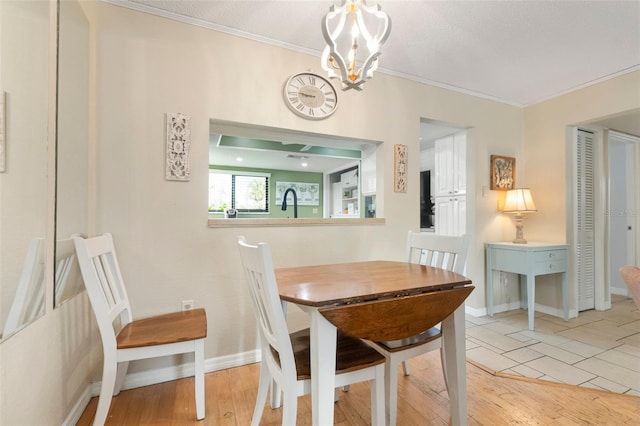 tiled dining area featuring an inviting chandelier and crown molding