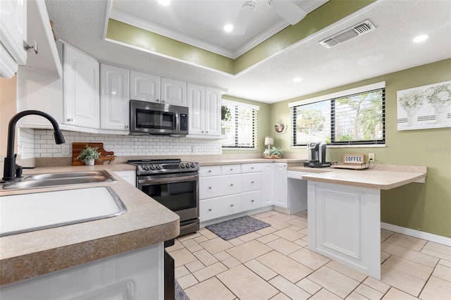 kitchen featuring crown molding, sink, tasteful backsplash, white cabinetry, and stainless steel appliances