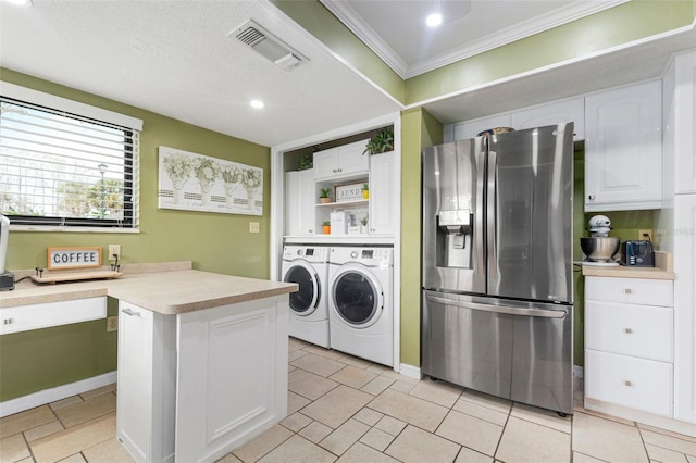 washroom with a textured ceiling, crown molding, and washing machine and clothes dryer