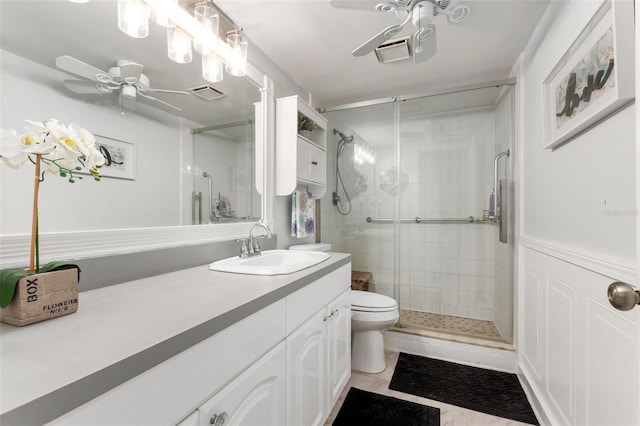 bathroom featuring ceiling fan, tile patterned floors, an enclosed shower, toilet, and vanity