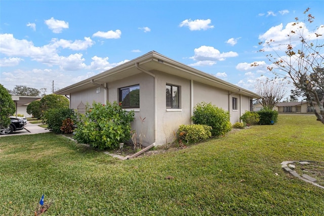 view of property exterior with a yard