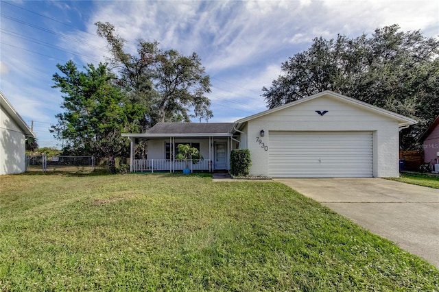 ranch-style house with a front lawn, covered porch, and a garage