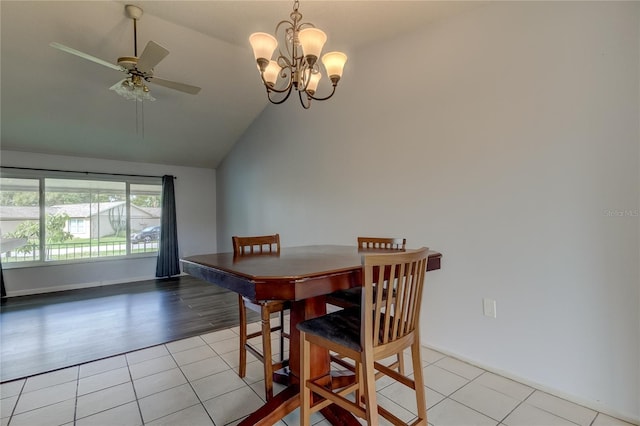 tiled dining area featuring ceiling fan with notable chandelier and vaulted ceiling