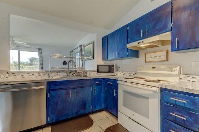 kitchen with stainless steel appliances, blue cabinets, and light tile patterned flooring