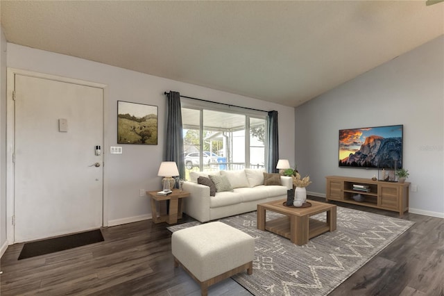 living room with dark wood-style floors, lofted ceiling, and baseboards