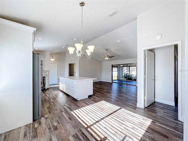 kitchen featuring stainless steel fridge, a kitchen island, pendant lighting, and dark hardwood / wood-style floors