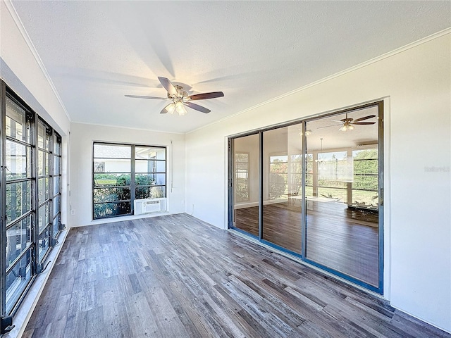 unfurnished sunroom featuring ceiling fan