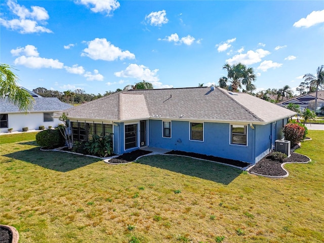 back of house with a sunroom, a yard, and central AC unit