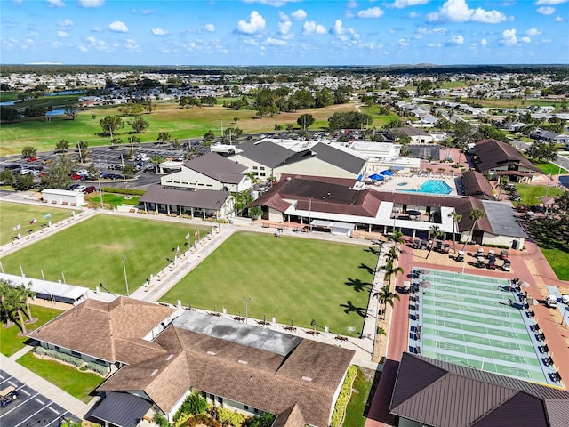 aerial view of residential area featuring a nearby body of water and a pool