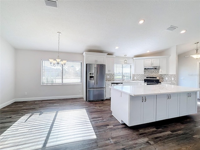 kitchen featuring stainless steel appliances, dark wood-style floors, tasteful backsplash, white cabinetry, and recessed lighting