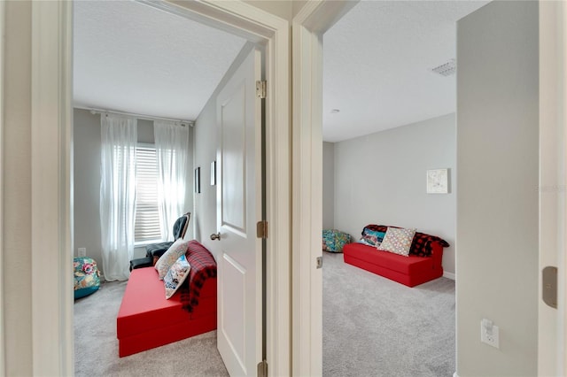 bedroom with a textured ceiling and light carpet