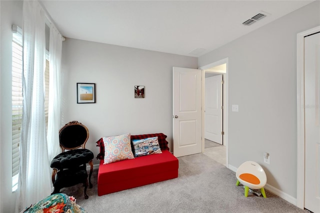 living area with light colored carpet