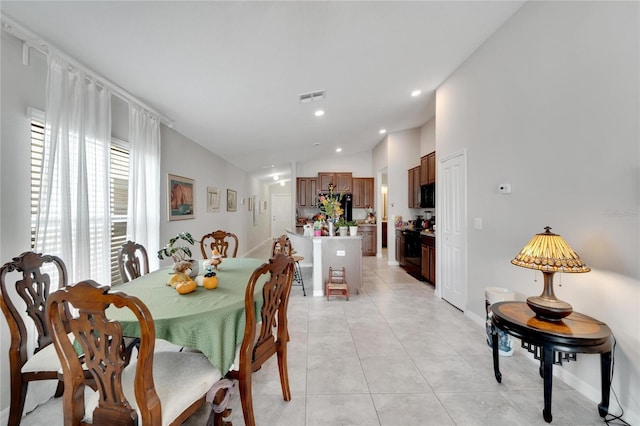 tiled dining space with vaulted ceiling