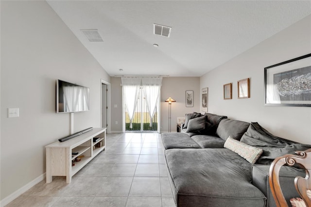 tiled living room featuring vaulted ceiling