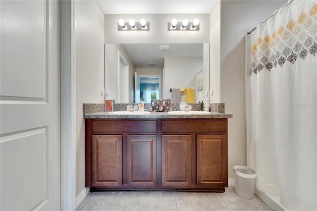 bathroom featuring a shower with shower curtain, vanity, and tile patterned floors